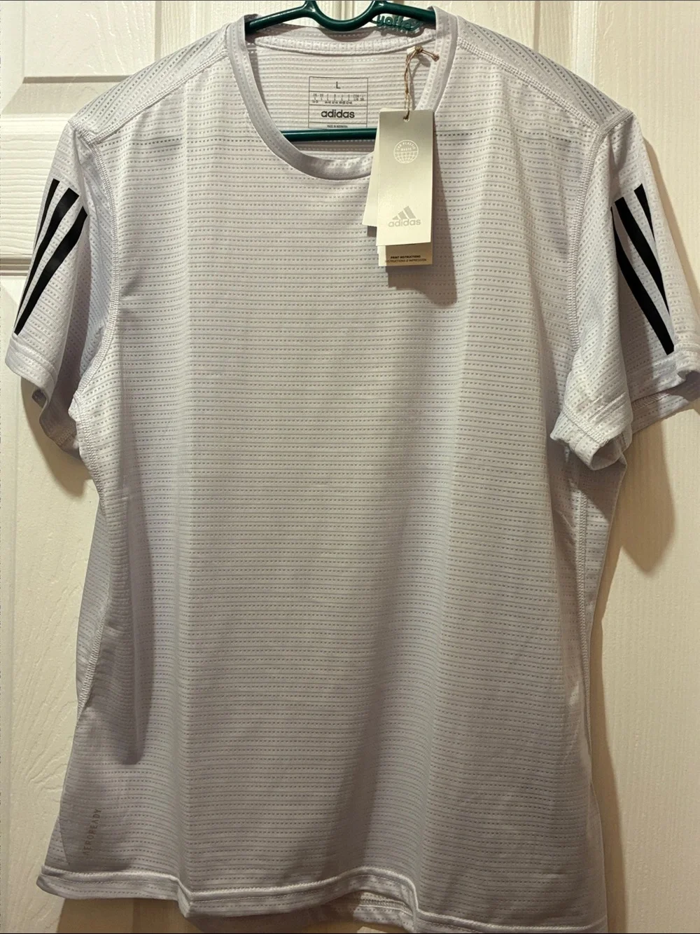 adidas Aeroready Men’s running tee in a light gray and signature stripes.